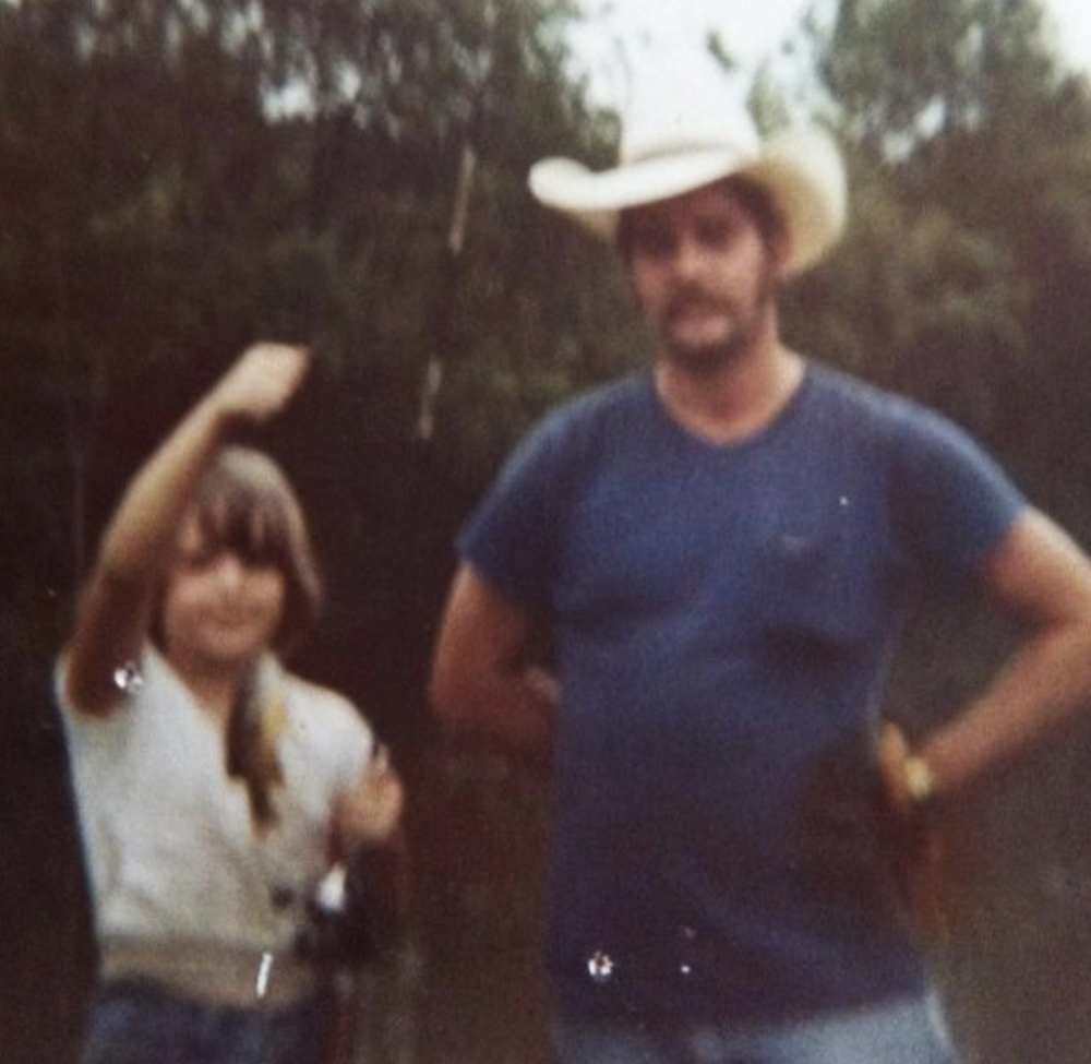 Laura fishing with her father during childhood