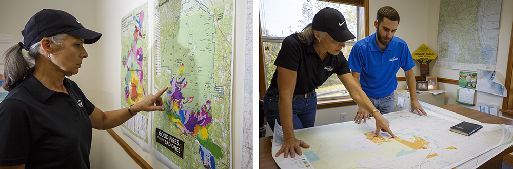 Forresters look at maps to determine fire danger information