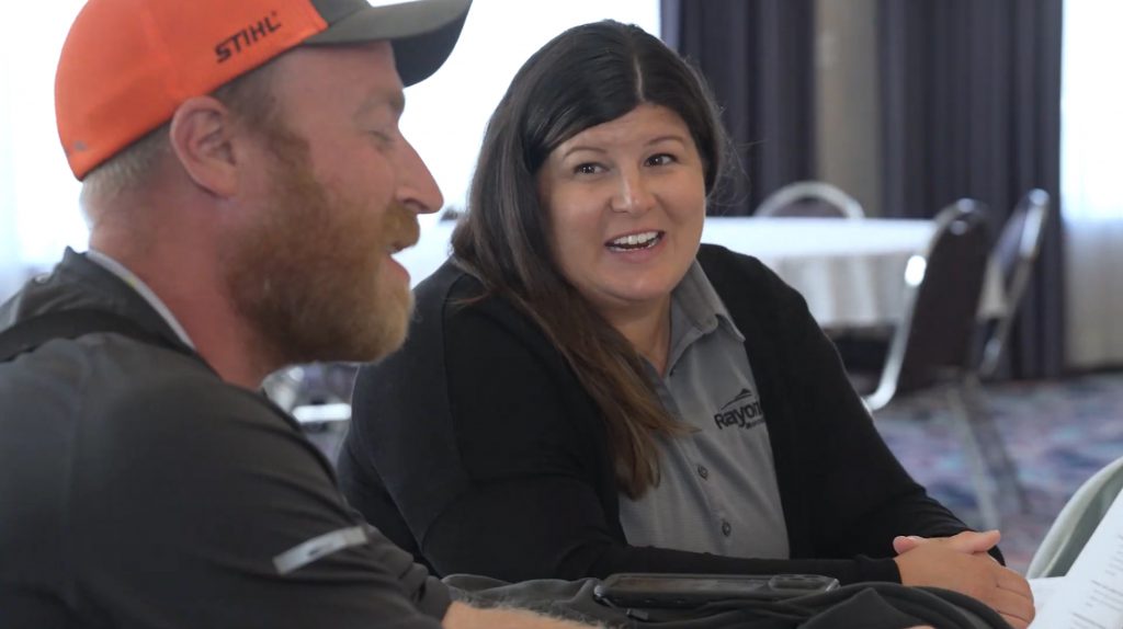Tracie Gibbs sits at a table with a trainee